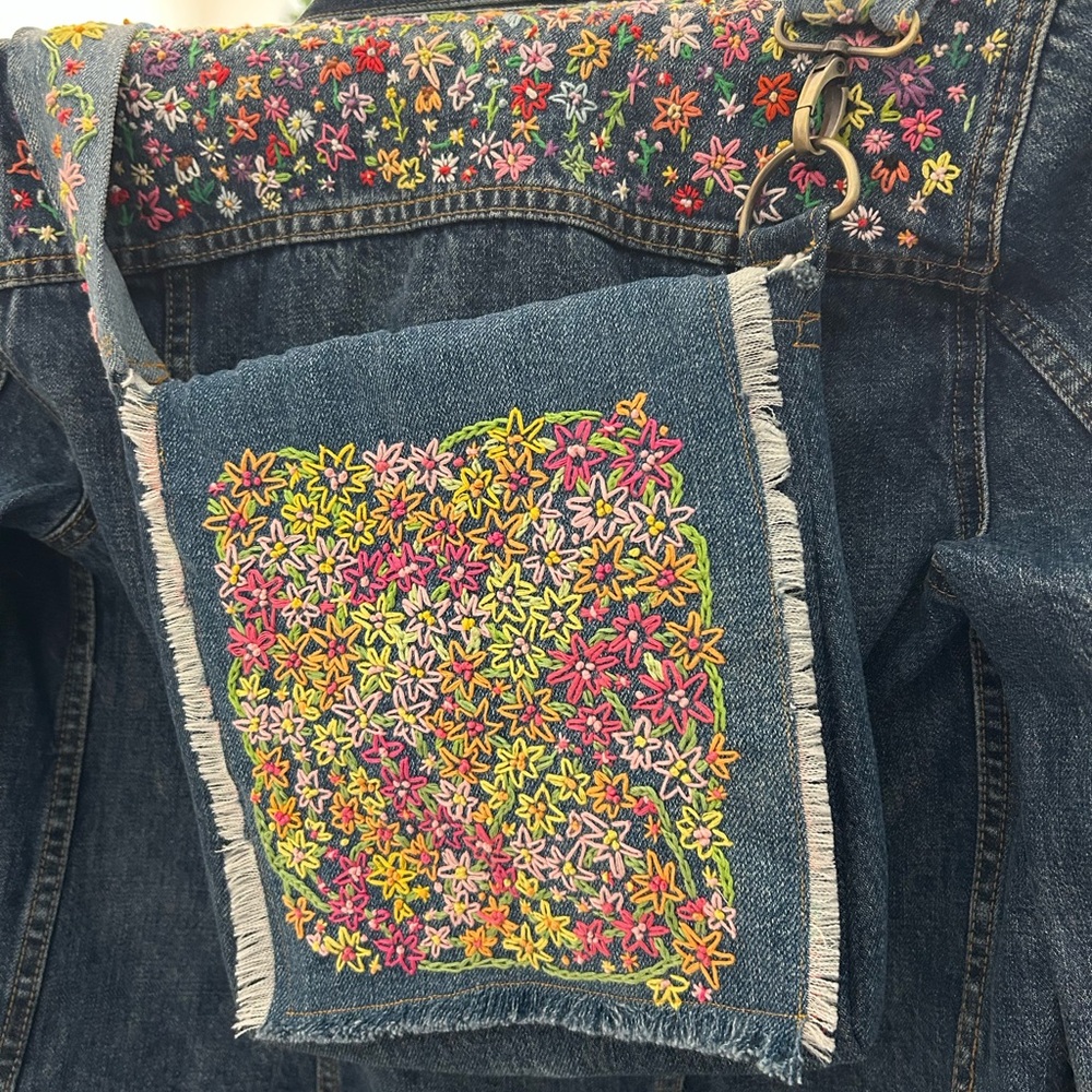 Hand Embroidered crossbody bag. Handmade from recycled Levi’s Floral lining
